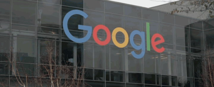 A wide-angle view of Google headquarters, showcasing the modern architecture, landscaped surroundings, and the iconic Google logo on the building.